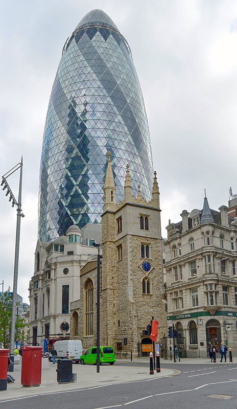 27 - The historic St Andrew Undershaft church in the foreground with the modern skyscraper known as The Gherkin rising behind it in the City of London